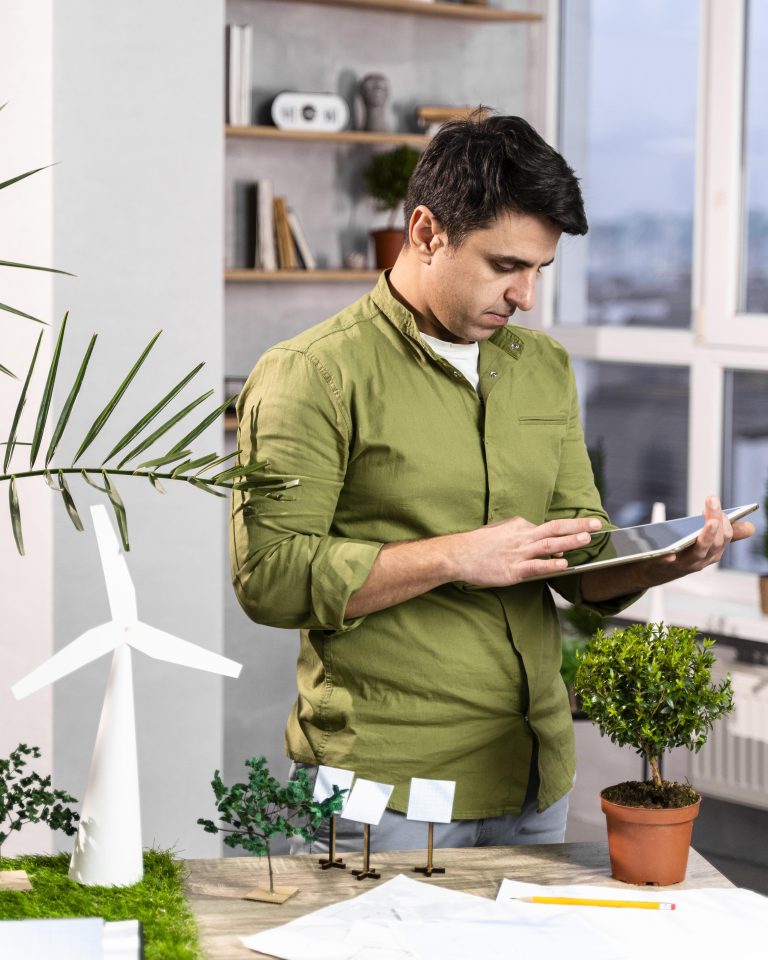 man-using-tablet-eco-friendly-wind-power-project-layout Image description